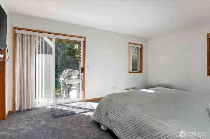Main level primary bedroom showing patio access.
