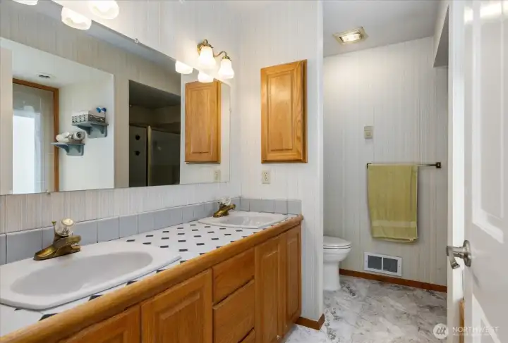 Primary bath has double vanity, separate shower and jetted tub.
