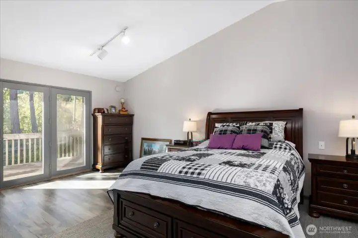Upstairs primary bedroom has access to a nice deck overlooking the lovely back yard.