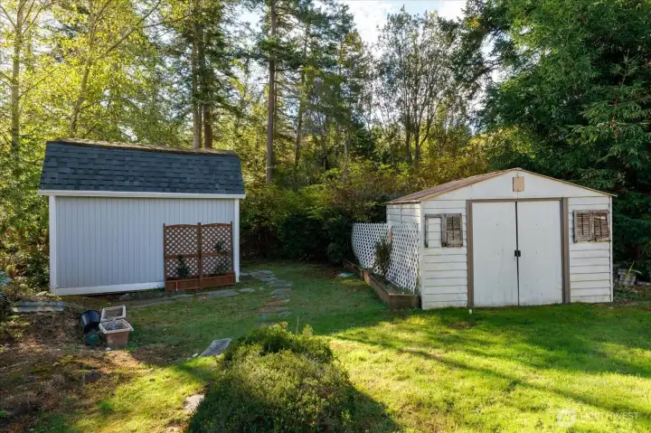 Garden/storage sheds tucked away in back yard