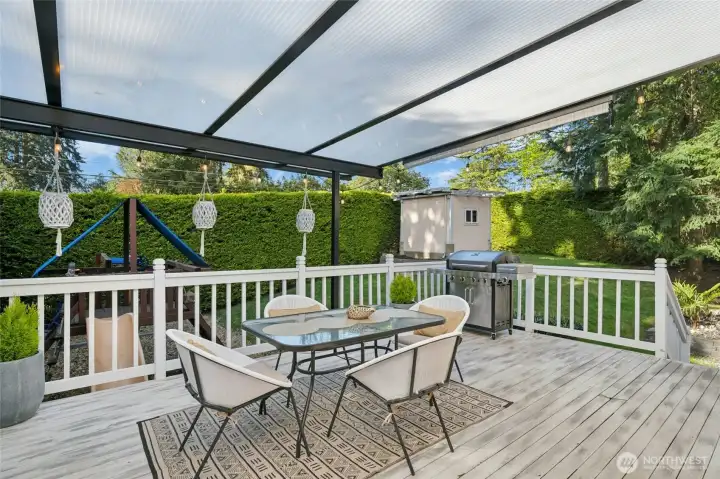 The private backyard includes a grassy lawn, playset and storage shed, creating a wonderful setting for outdoor enjoyment.