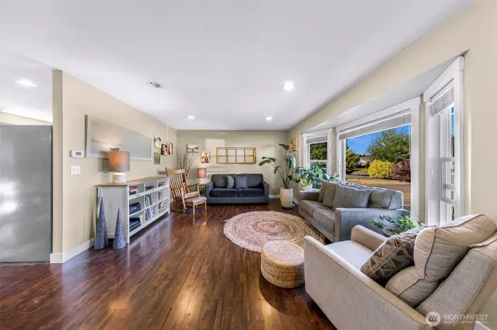 Inviting living room with large picture windows that bring in abundant natural light Inviting living room with large picture windows that bring in abundant natural light