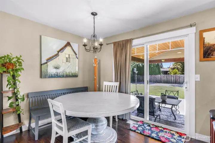 The dining area opens to the covered patio through a sliding glass door, extending the living space into the backyard The dining area opens to the covered patio through a sliding glass door, extending the living space into the backyard