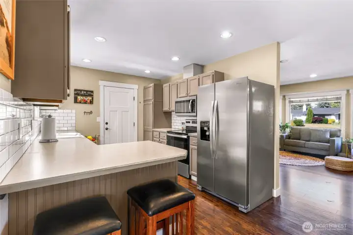 Efficient galley kitchen provides abundant storage, ample workspace, and a breakfast bar overlooking the living area Efficient galley kitchen provides abundant storage, ample workspace, and a breakfast bar overlooking the living area