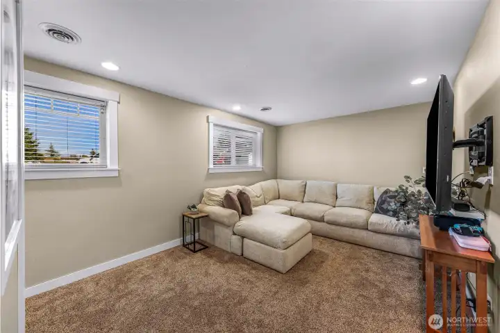 Lower-level family room offers a comfortable space for movie nights, games, or a home office Lower-level family room offers a comfortable space for movie nights, games, or a home office