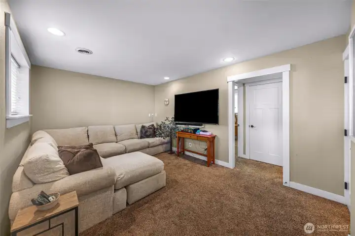 The lower-level family room offers plenty of space for relaxing, movie nights, or gathering with family and friends The lower-level family room offers plenty of space for relaxing, movie nights, or gathering with family and friends