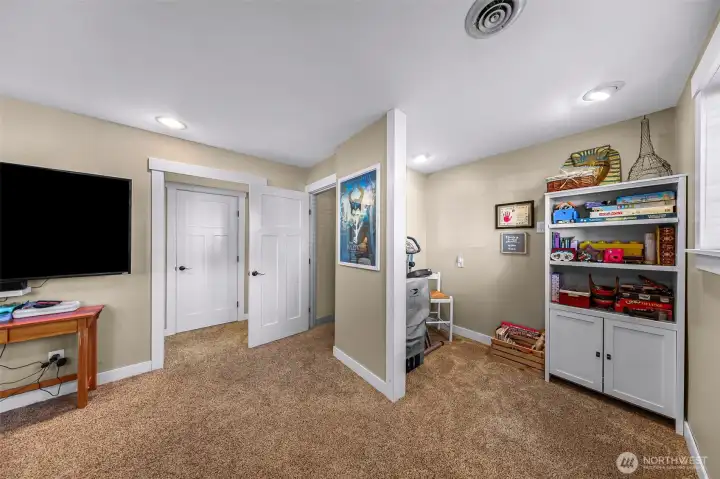 Lower-level family room includes a flexible alcove that's ideal for a home office, play area, exercise space, or hobby area Lower-level family room includes a flexible alcove that's ideal for a home office, play area, exercise space, or hobby area