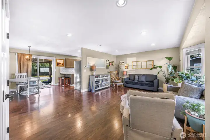 Bright open living area with durable hardwood floors, recessed lighting, and an easy flow to the dining area, kitchen, and covered patio Bright open living area with durable hardwood floors, recessed lighting, and an easy flow to the dining area, kitchen, and covered patio