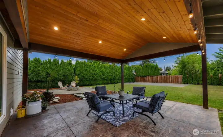Looking the other way towards the fire pit from the covered back patio. Looking the other way towards the fire pit from the covered back patio.