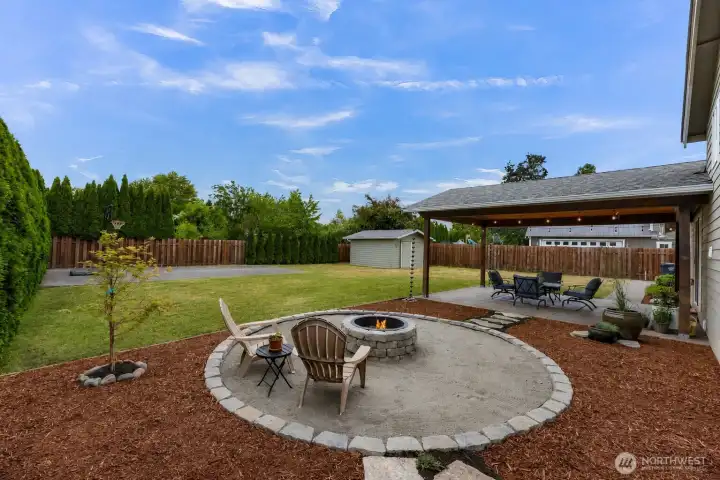 Come enjoy the summer here in this beautiful back yard space. Fire pit is ready for you and the covered patio gives you shade right off the kitchen Come enjoy the summer here in this beautiful back yard space. Fire pit is ready for you and the covered patio gives you shade right off the kitchen