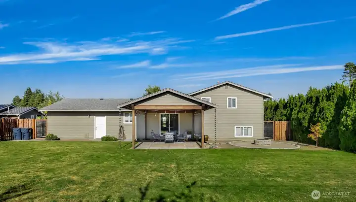 Backyard showing the covered patio and circular fire pit. Gates on both sides of this home & fully fenced. Backyard showing the covered patio and circular fire pit. Gates on both sides of this home & fully fenced.