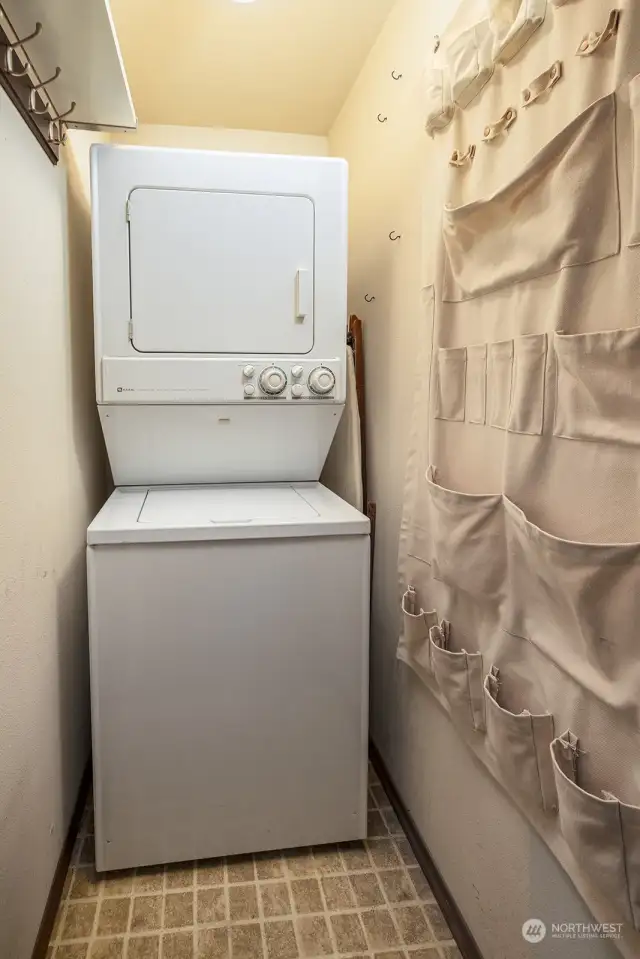 Washer and dryer in unit and has extra space for storage, or cleaning items.