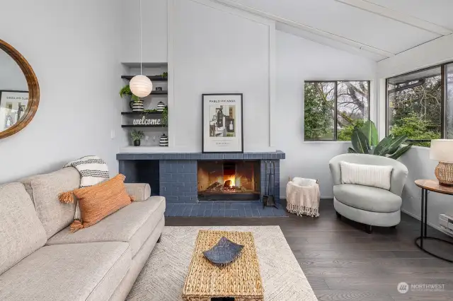 The wood burning fireplace is the focal feature of this cool mid-mod home.  Built in shelving and wood storage.