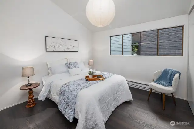 Bedroom also features vaulted ceilings and is shown here with a queen bed, but a king bed could fit.