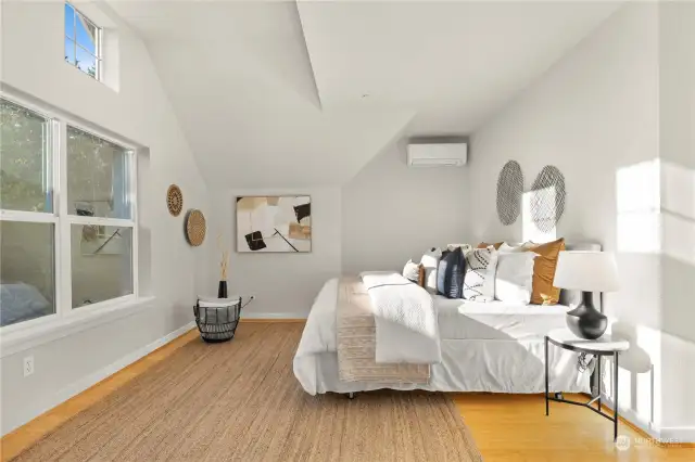 Large primary bedroom on the 3rd level with vaulted ceilings.