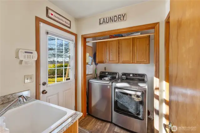 Laundry room with adjoining half bath.