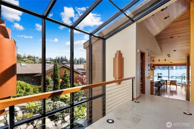 Custom architectural masterpiece features soaring clear cedar ceilings, walls of floor-to-ceiling windows