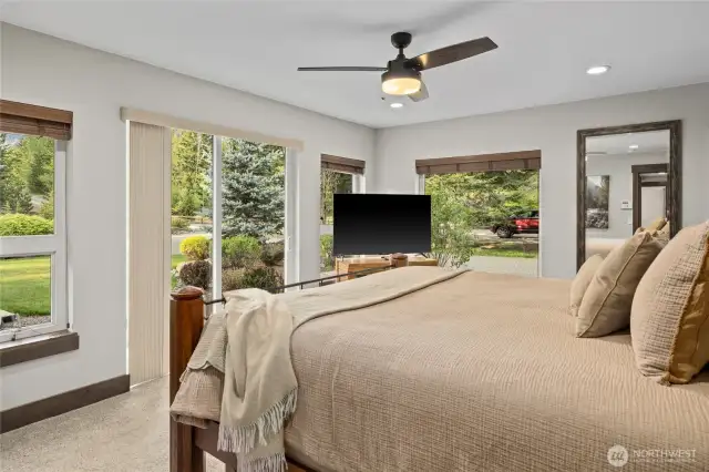 Primary bedroom with slider to the park like yard.