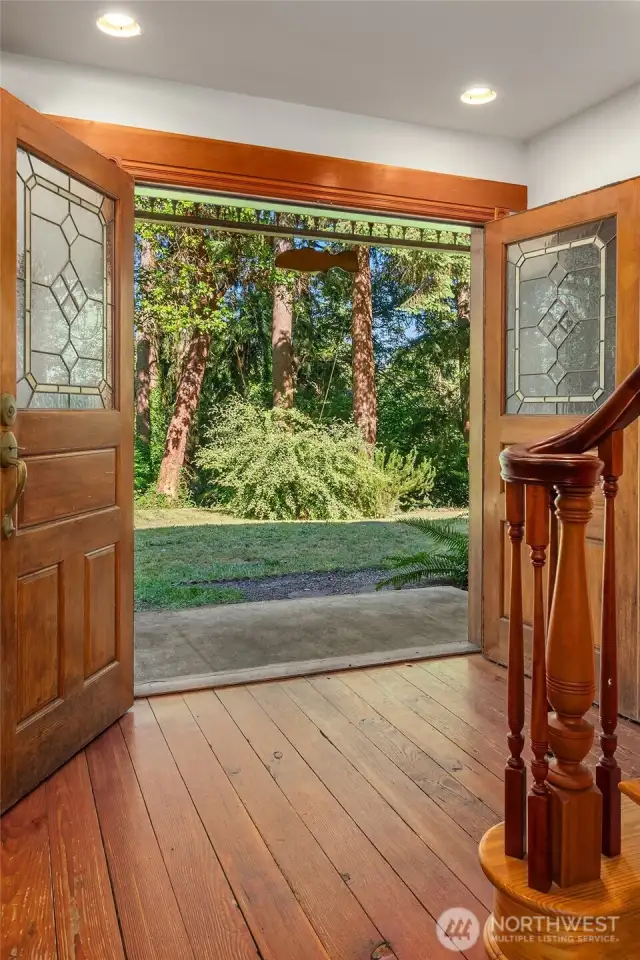 Looking back through the front doors with true divided light and leaded glass windows. Front lawn is a great spot for games!