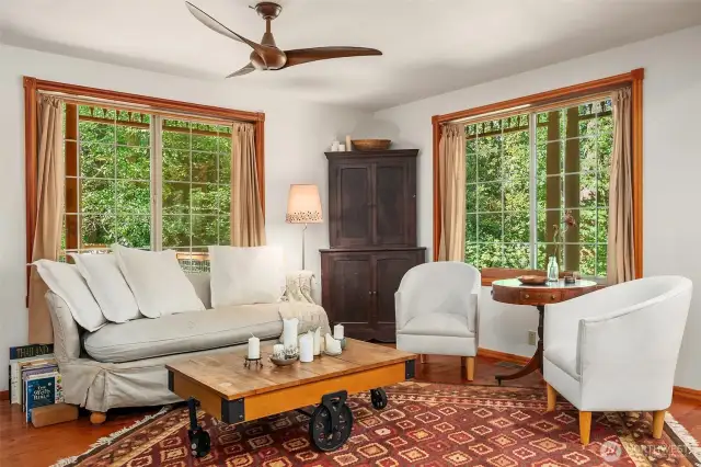 Living room enjoys light streaming in from the east and north and opens onto the kitchen/dining areas.