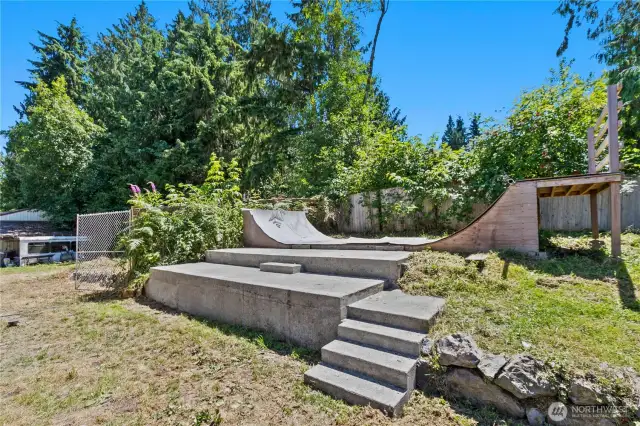 Half pipe in side yard! Needs some love but amazing feature!