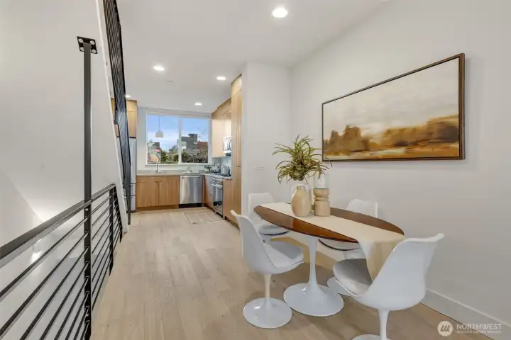 Dining room space! High ceilings distort the photo; In person this is great volume.