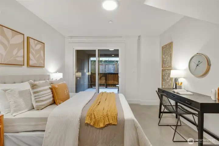 Lowest level bedroom has direct access to the covered space. Concrete floors allow for a myriad of uses.