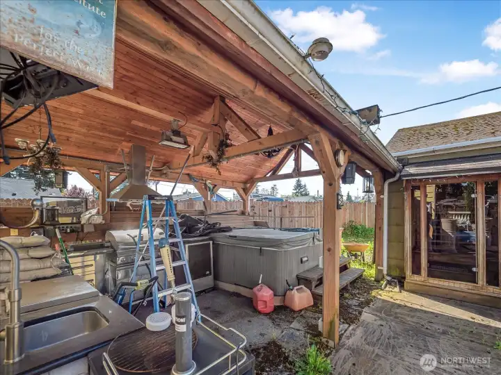 Covered shed with hot tub and outdoor kitchen