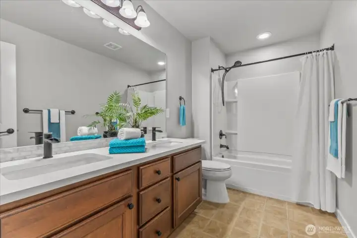 Secondary Bathroom with dual sinks.