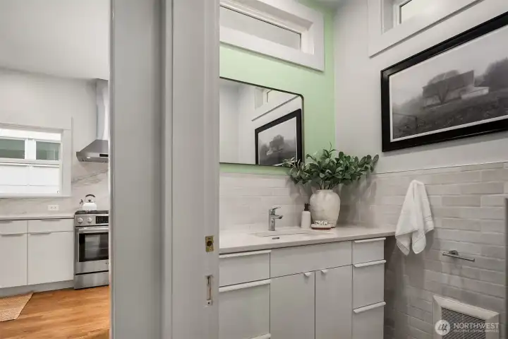 Darling powder room located on the main floor between the kitchen and living rooms.