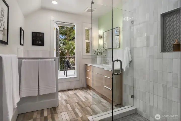 The primary bathroom has heated floors, designer tile, and floating Toto toilet.