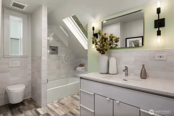 The full bathroom upstairs has a skylight, heated floors, Toto floating toilet and dsigner tile.