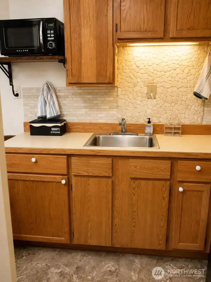 Kitchen with microwave, fridge and stove