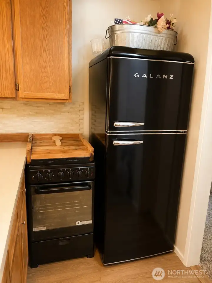 Kitchen with microwave, stove and fridge