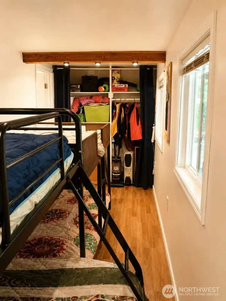 Bedroom with double bunkbeds and closet for storage