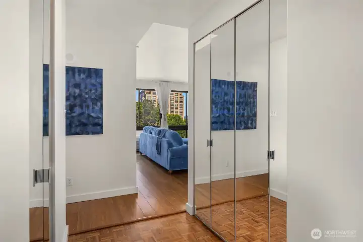 Entry with two sets of double closets and parquet wood floor