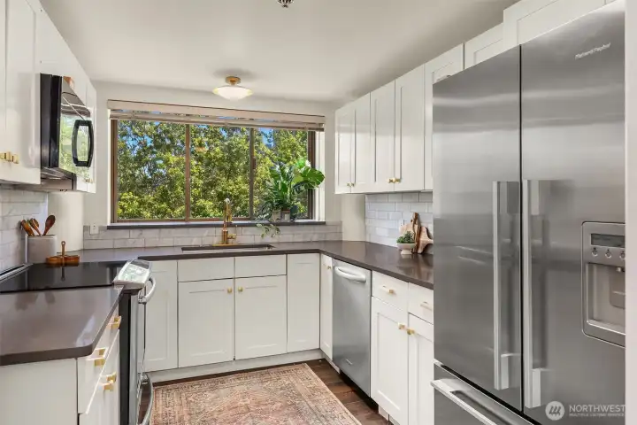 Updated kitchen has stainless steel appliances and abundant storage