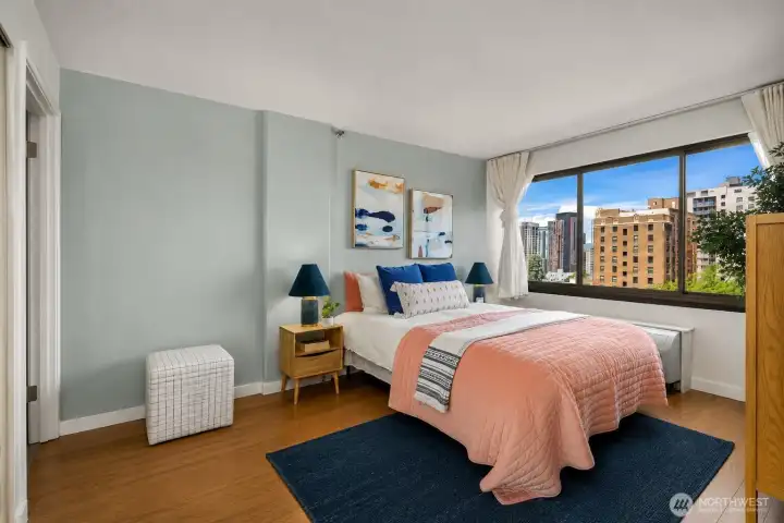 Primary bedroom with double closet has room for a king bed and side tables