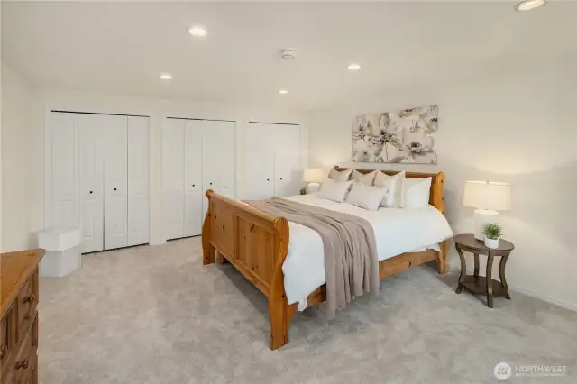 Primary bedroom with a wall of closets
