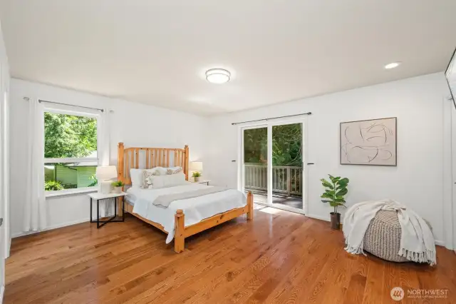 Primary bedroom with easy access to the back deck an en-suite updated bathroom with a large walk in shower and 3 closets!