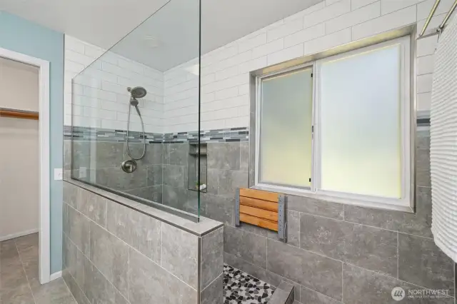 Your going to love this shower! Recently updated primary bathroom with LED back lit mirrors a resting bench and plenty of room.