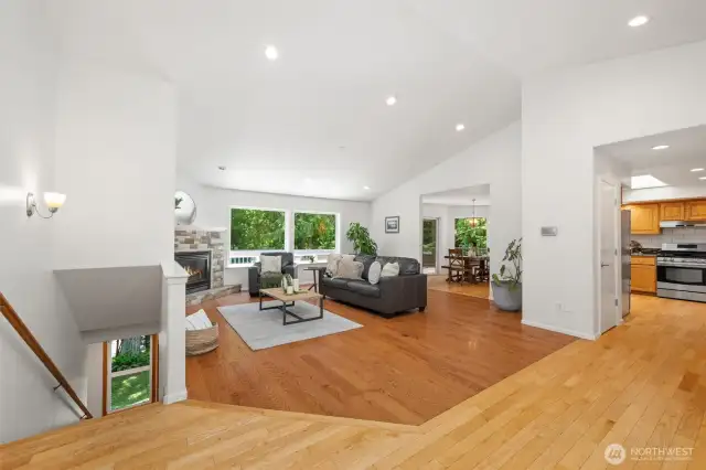 The main level features vaulted ceilings, rich oak flooring, and picture windows that frame your nearly half-acre forested lot—like living in your own private treehouse.