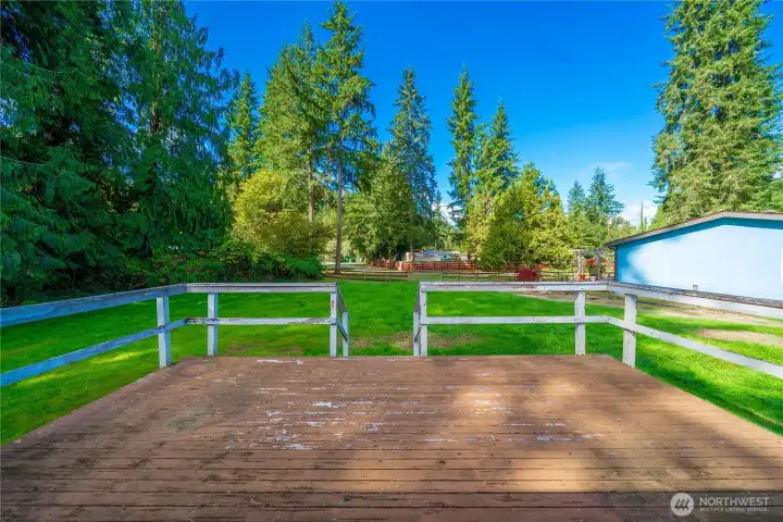 Patio & backyard with community pool in the background.