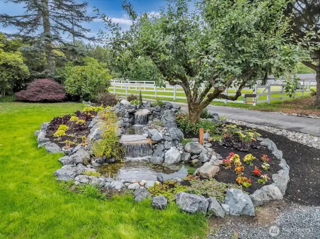 Beautiful water feature with stone and plants surrounding it!