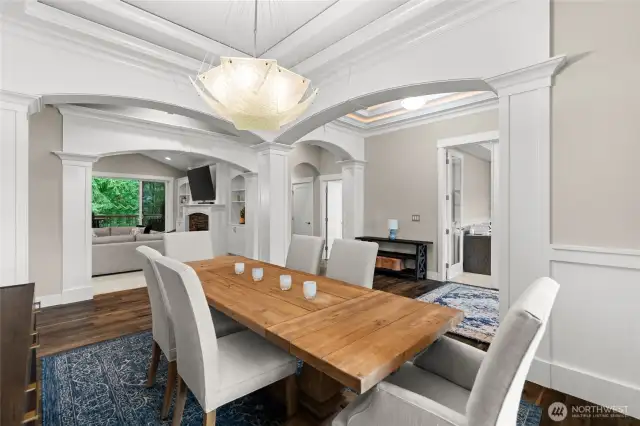 Just off the kitchen, a beautiful formal room offers the perfect setting for elegant occasions and large gatherings. A striking light fixture adds a modern flair, enhancing the home's timeless architecture.