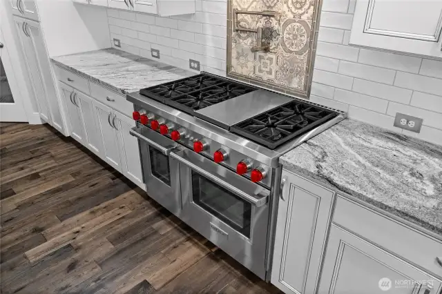 Unleash your inner chef with top-of-the-line Wolf appliances, perfect for crafting gourmet meals and delectable baked goods. A convenient pot filler above the stove adds both style and function, making cooking easier—and more enjoyable.