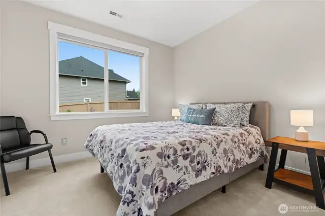 One of two guest suites on the main floor are spacious, with an oversized window and plush new carpeting.