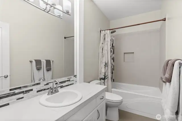 A shared full bathroom is conveniently located between 2 guest suites on the main level.