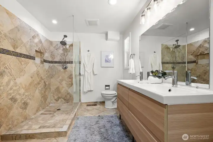 Primary bathroom features a double sink and a walk-in shower.