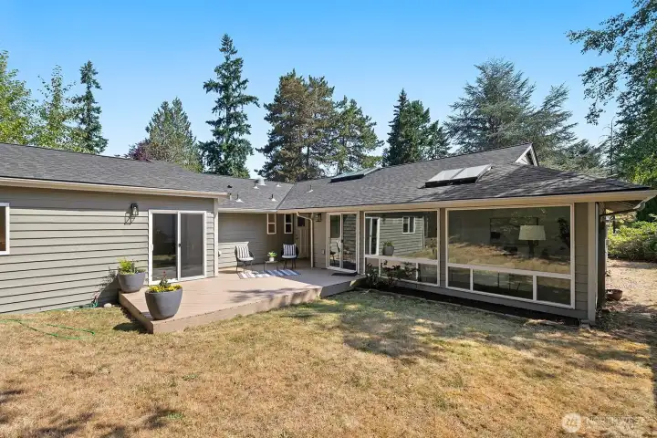 Backyard features a large freshly painted deck and plenty of grass to run around.